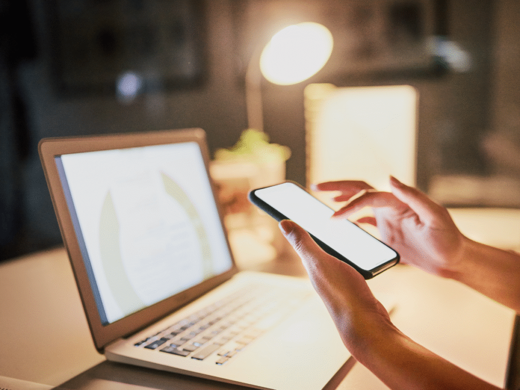 image showing laptop and movile phone working on scheduled and manual social media posts